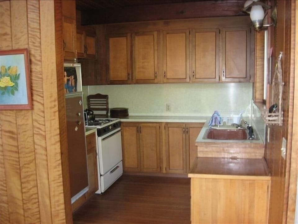 The kitchen has propane stove, oven & fridge