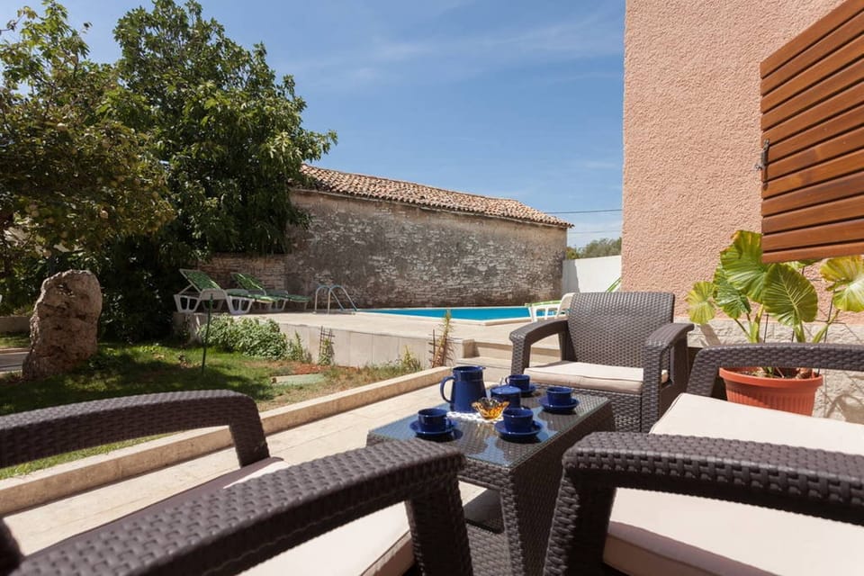 Garden furniture where you can drink coffee or tea while kids enjoy the pool