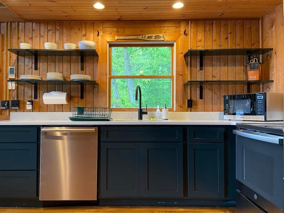 The kitchen boasts custom cabinetry, quartz countertops, new stainless steel appliances, including a new dishwasher