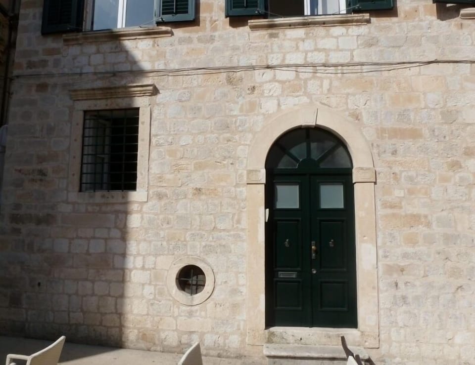 Entrance to the building. Large window on the left belongs to the apartment.