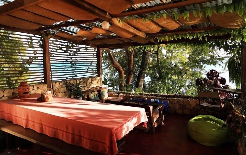 open air terrace in the middle of the trees overlooking the lake