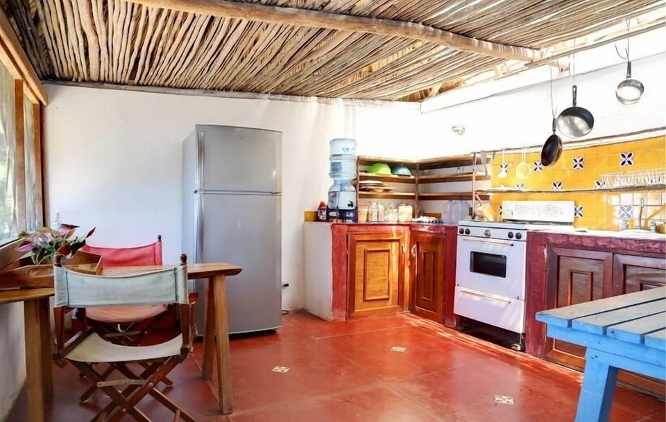 kitchen with big fridge/freezer and gas stove.