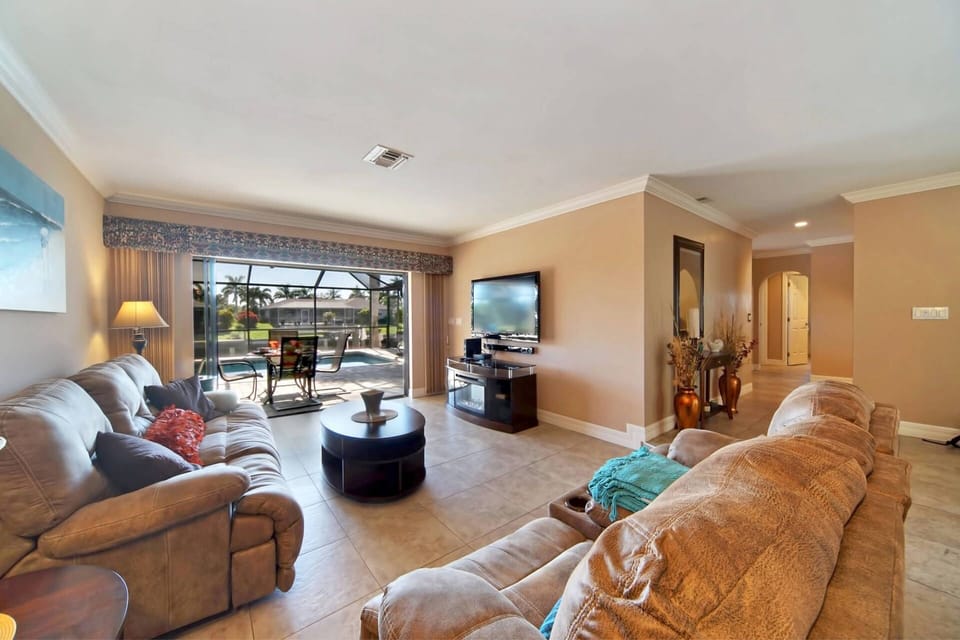 The living room offers recliners & a flat-screen TV