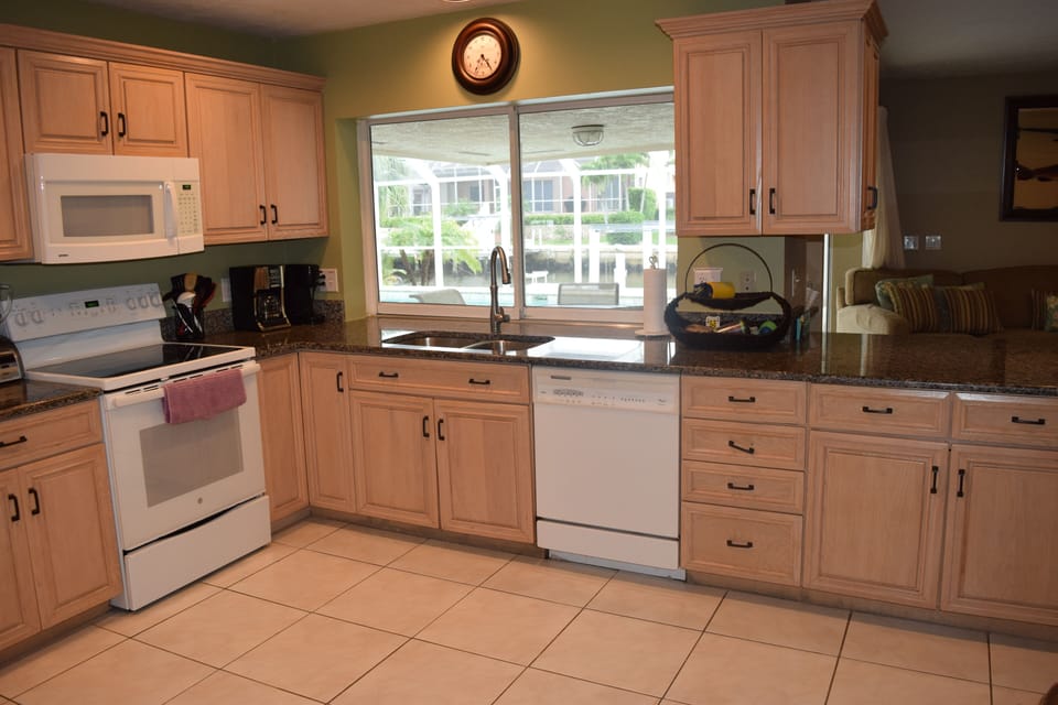 Well equipped kitchen with new granite countertops. Pass through window to lanai