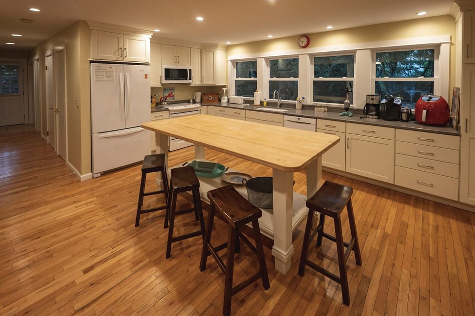 … and the open gourmet kitchen to the right; stairs, full bath, laundry ahead