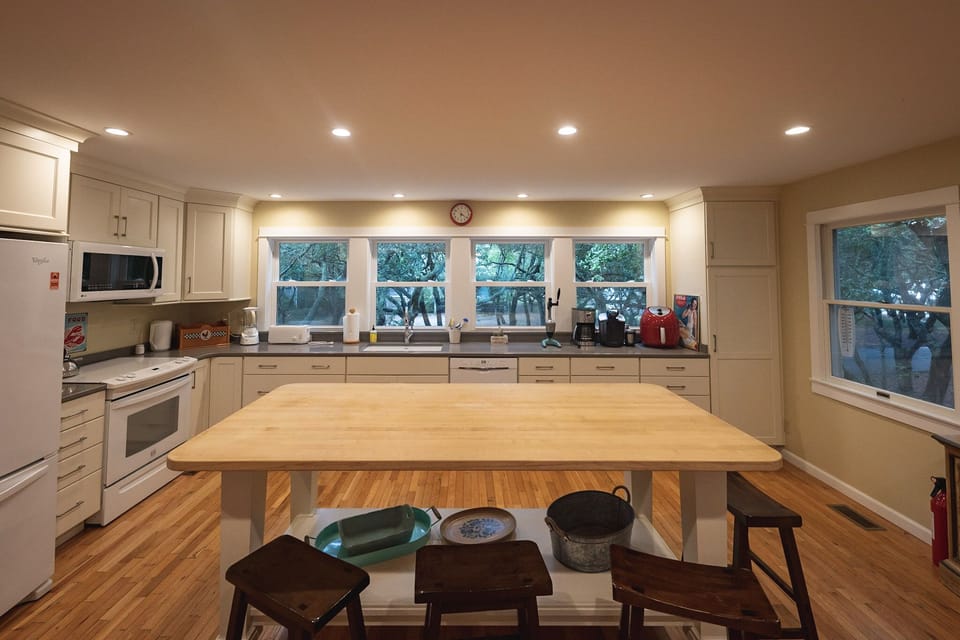 Windows galore, lights everywhere; a custom made huge island for prep and meals 