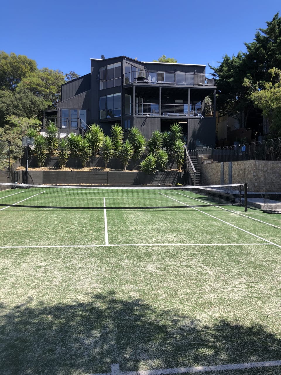 Tennis court with basketball ring and a view for the family 