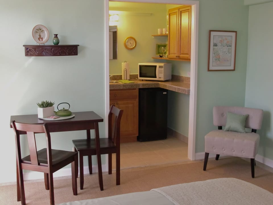#704A:
Dining Area with Sitting Chair and peek into Kitchenette Area