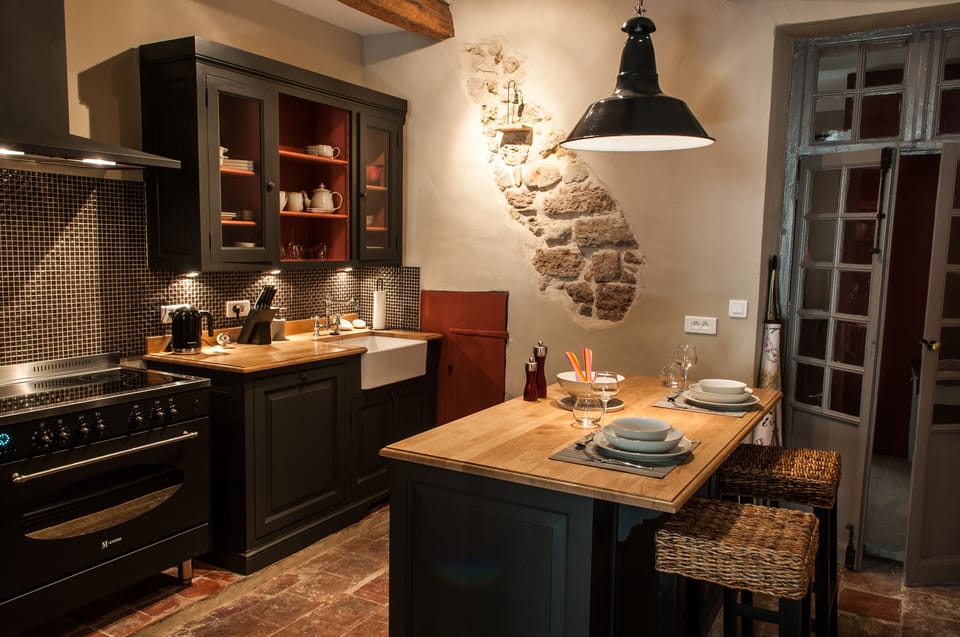 Custom designed kitchen with a hint of original stone wall
