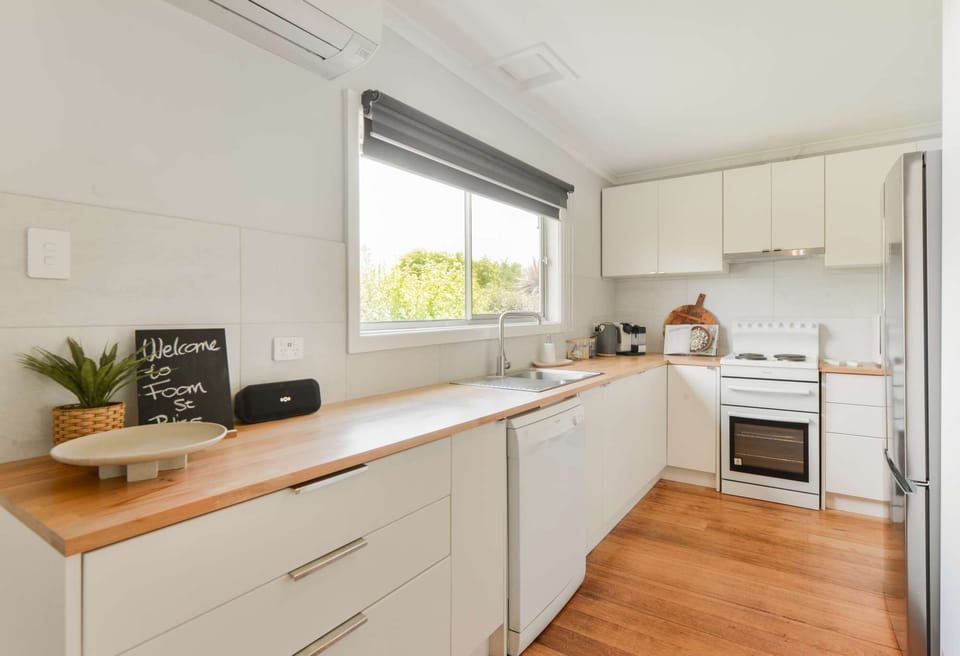 Fully equipped kitchen with oven, stove, microwave, kettle, toaster sand-which press, rice cooker and Nespresso pod coffee machine