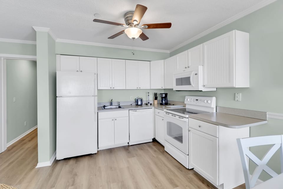Ocean Dunes Villa 405-Newly renovated Kitchen - The beautiful, all white kitchen has new appliances and a ceiling fan to keep cool while preparing your favorite meal.