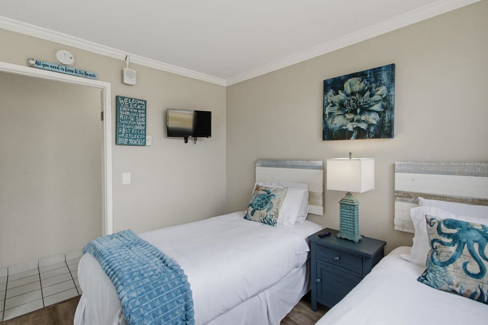 Twin bed guest room also features a TV