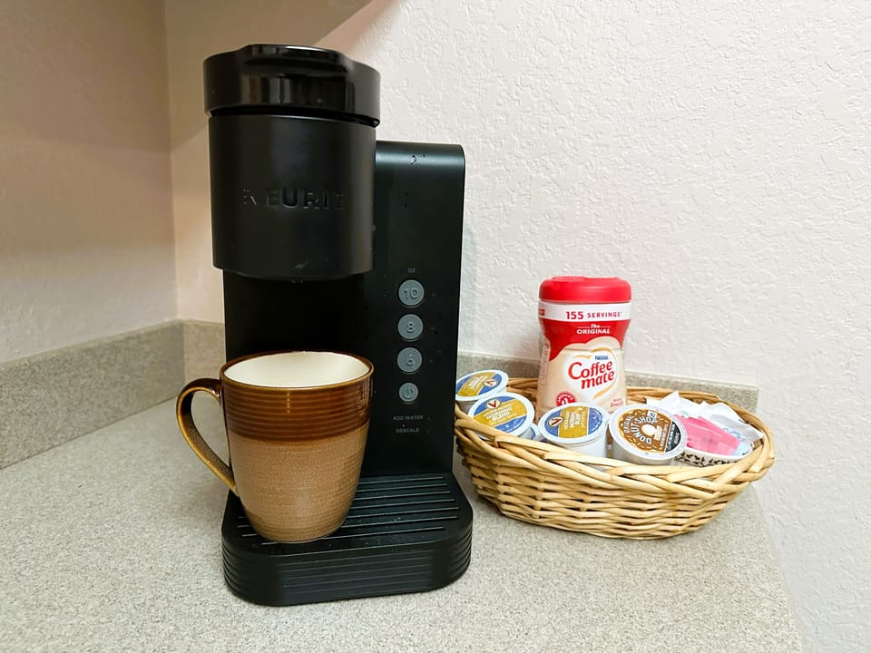 Keruig coffee machine, creamer and sweeteners.
