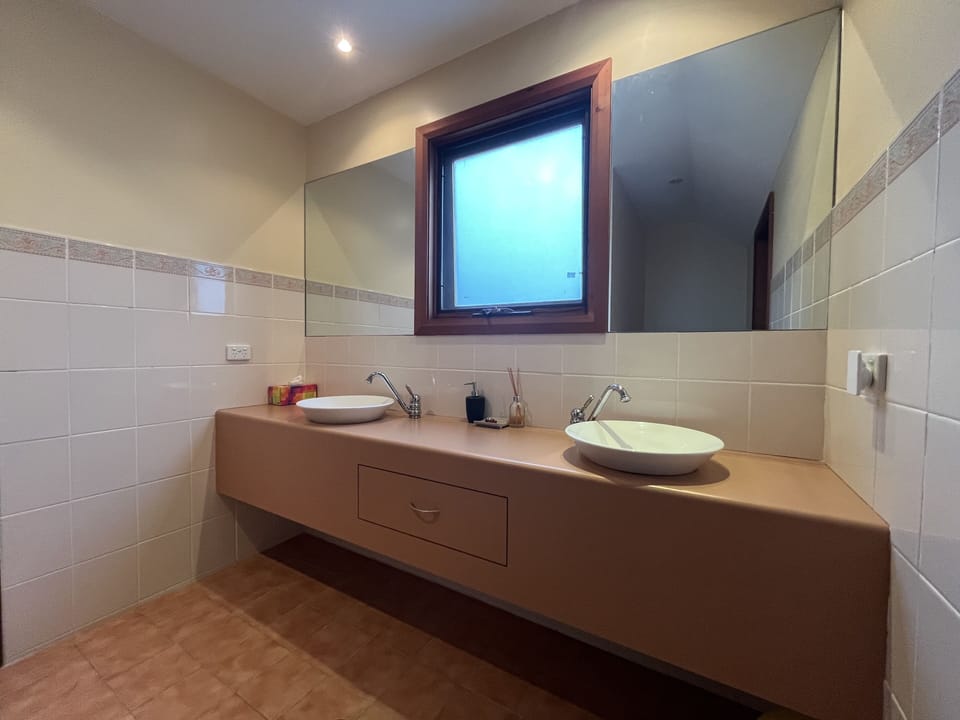 Main bathroom with double vanity and double shower heads