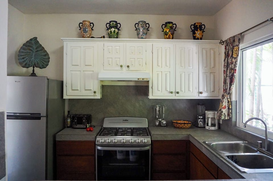 Fully equipped kitchen with oven, dishwasher, and full-size refrigerator.