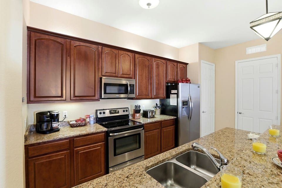 Modern kitchen with granite countertops and stainless-steel appliances.