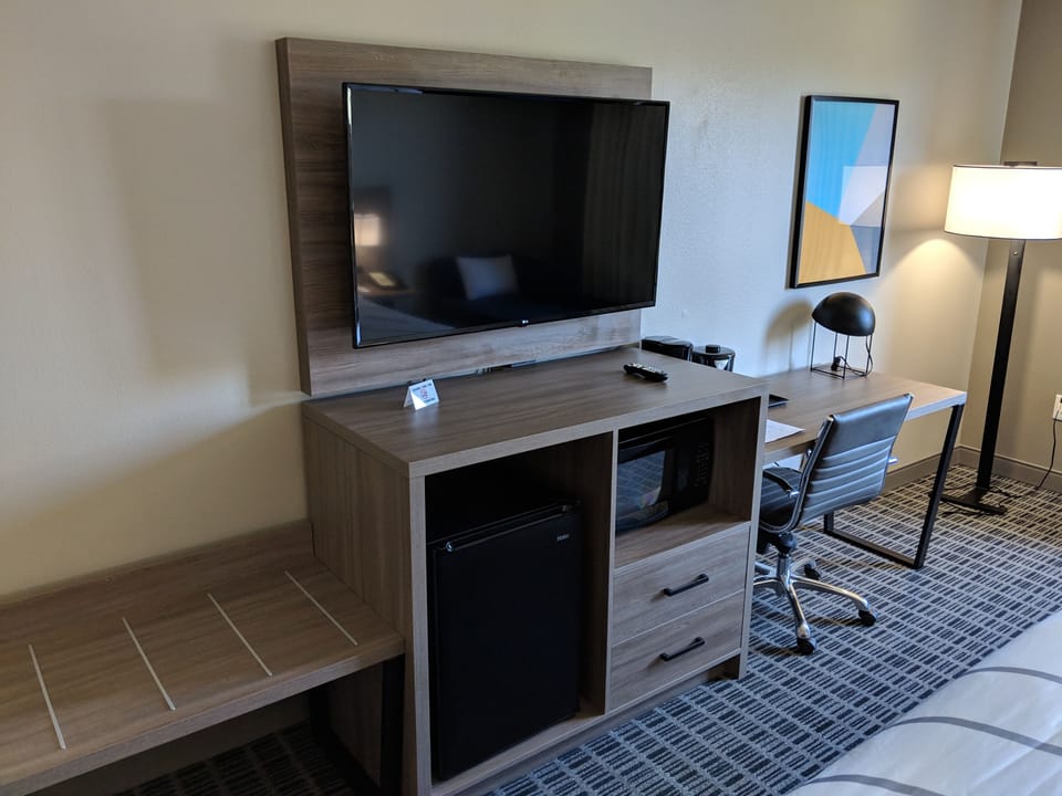 Premium bedding, desk, laptop workspace, blackout drapes