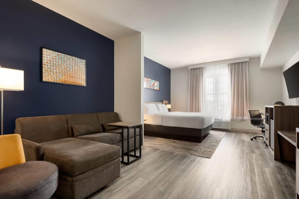 Premium bedding, desk, laptop workspace, blackout drapes