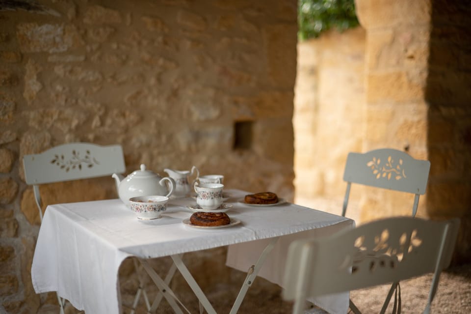 Petit dejeuner in the sheltered terrace overlooking the valley and Manoir.