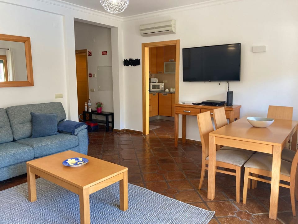 Livingroom with door to kitchen. Hall, guest bathroom & stairwell is on left
