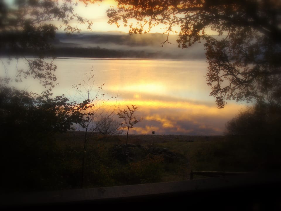 View of loch from veranda at sunset