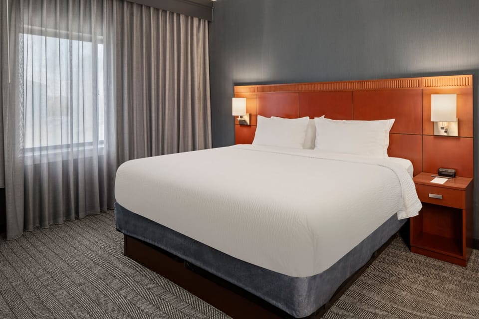 Premium bedding, desk, laptop workspace, blackout drapes