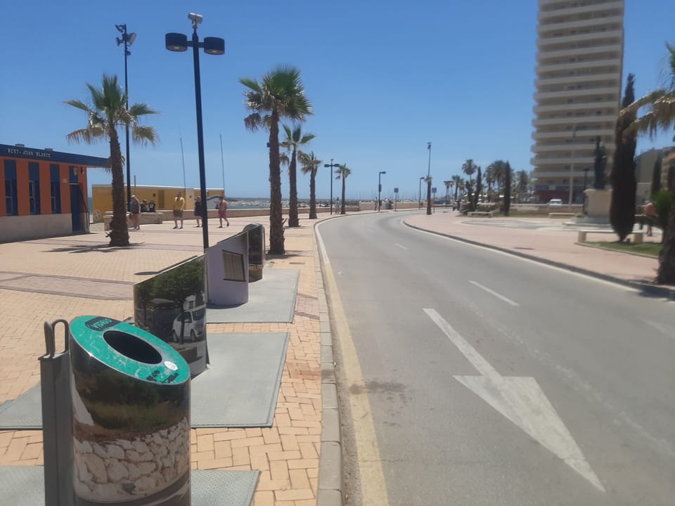 Recycle trash &
Skips at side of Majestic Stella Maris Aparthotel in background 