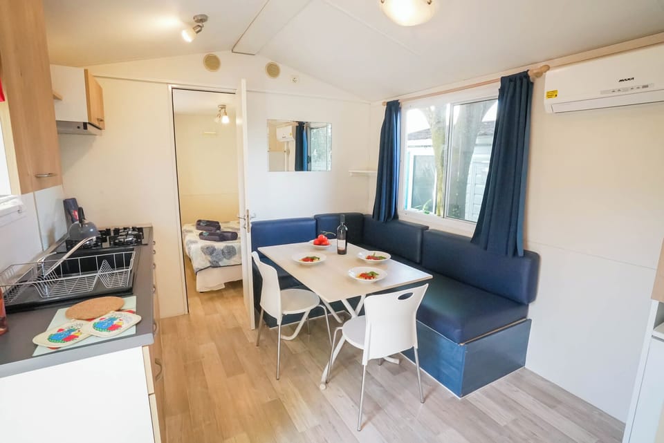 Standard Mobile Home | Private kitchen | Fridge, stovetop, cookware/dishes/utensils, dining tables