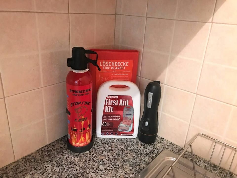 We have a fire extinguisher (serviced each year), first aid kit, fire blanket and torch. we have a smoke alarm as well. Spare bulbs and re-chargeable batteries are available in the supply cupboard.