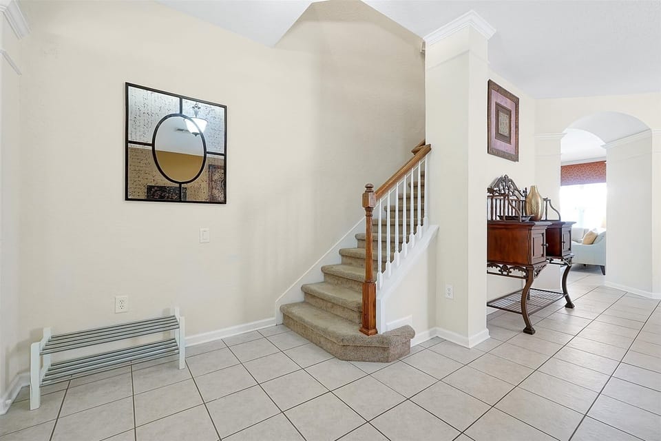 The staircase leading to the upstairs bedrooms from the spacious & bright foyer