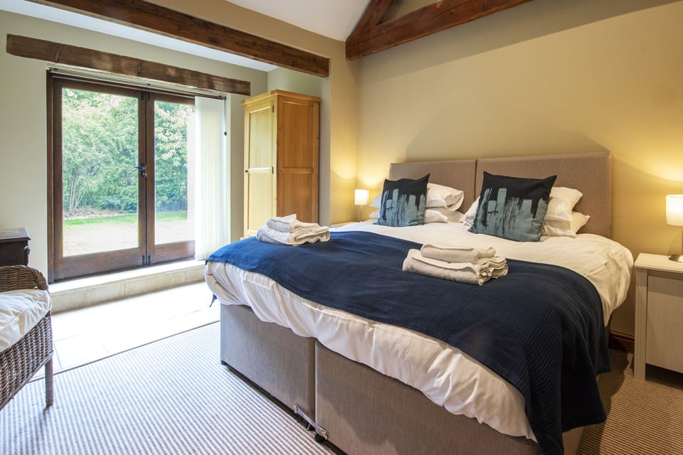downstairs bedroom with doors to enclosed back garden