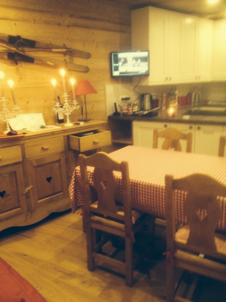 The open plan kitchen and dining area, with a TV.