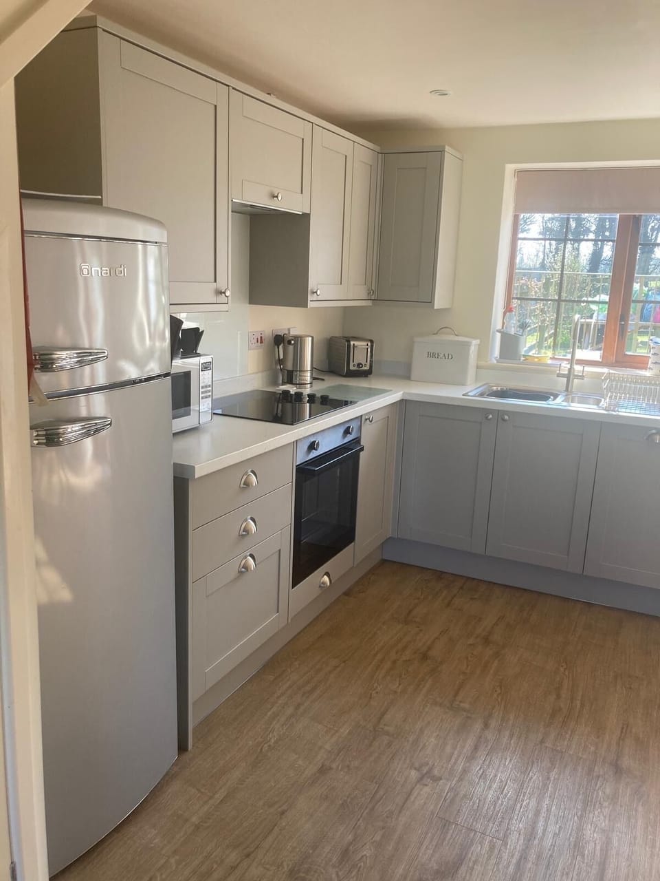 Newly fitted kitchen with integrated dishwasher and larder fridge