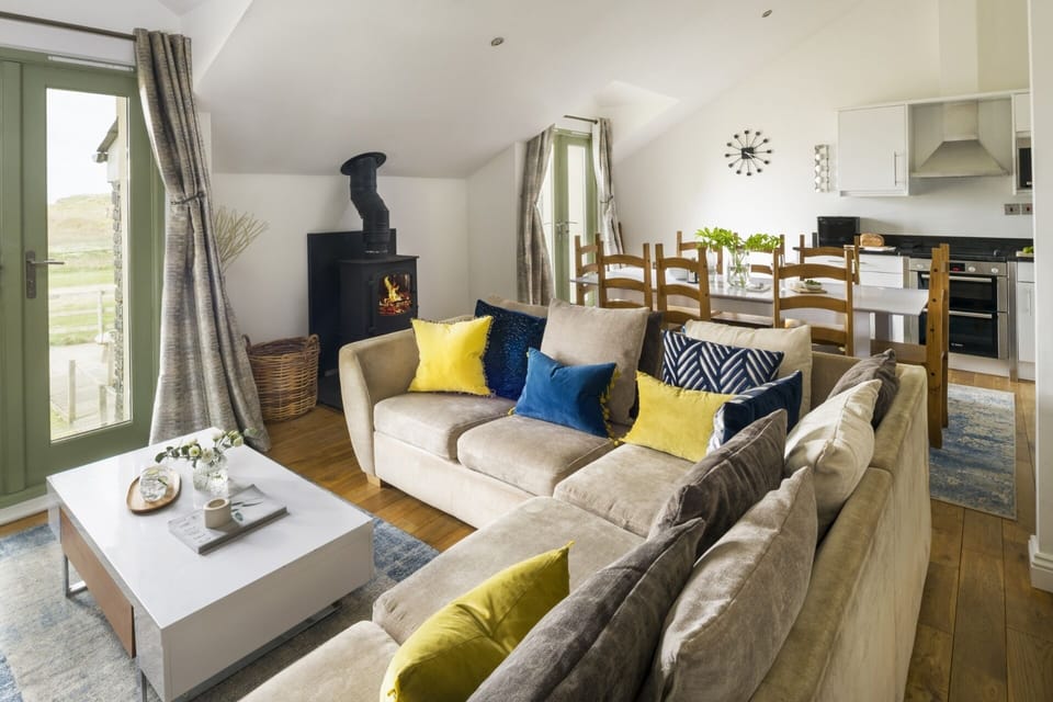 Living space with log burner at Llawnroc coastal holiday home