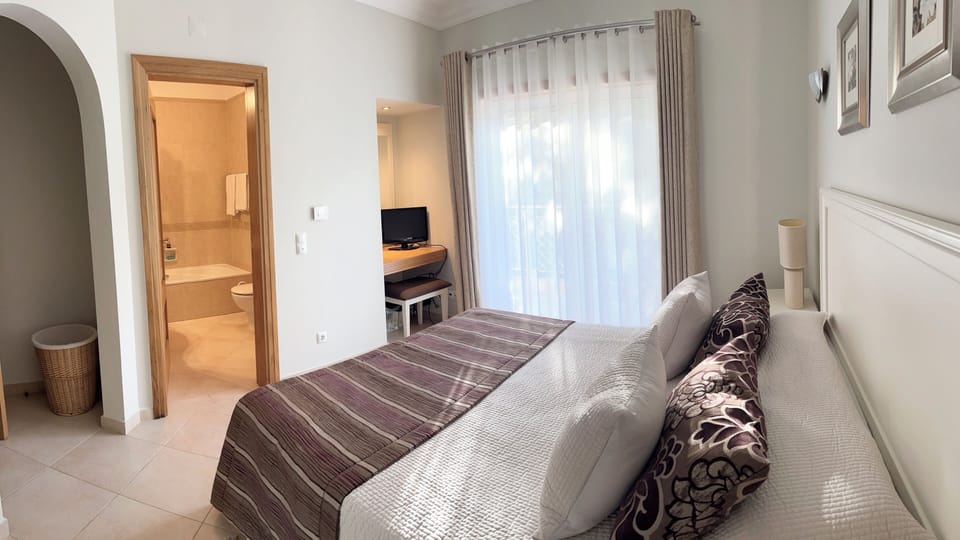 Master Bedroom with en-suite, and Patio doors leading to an elevated balcony