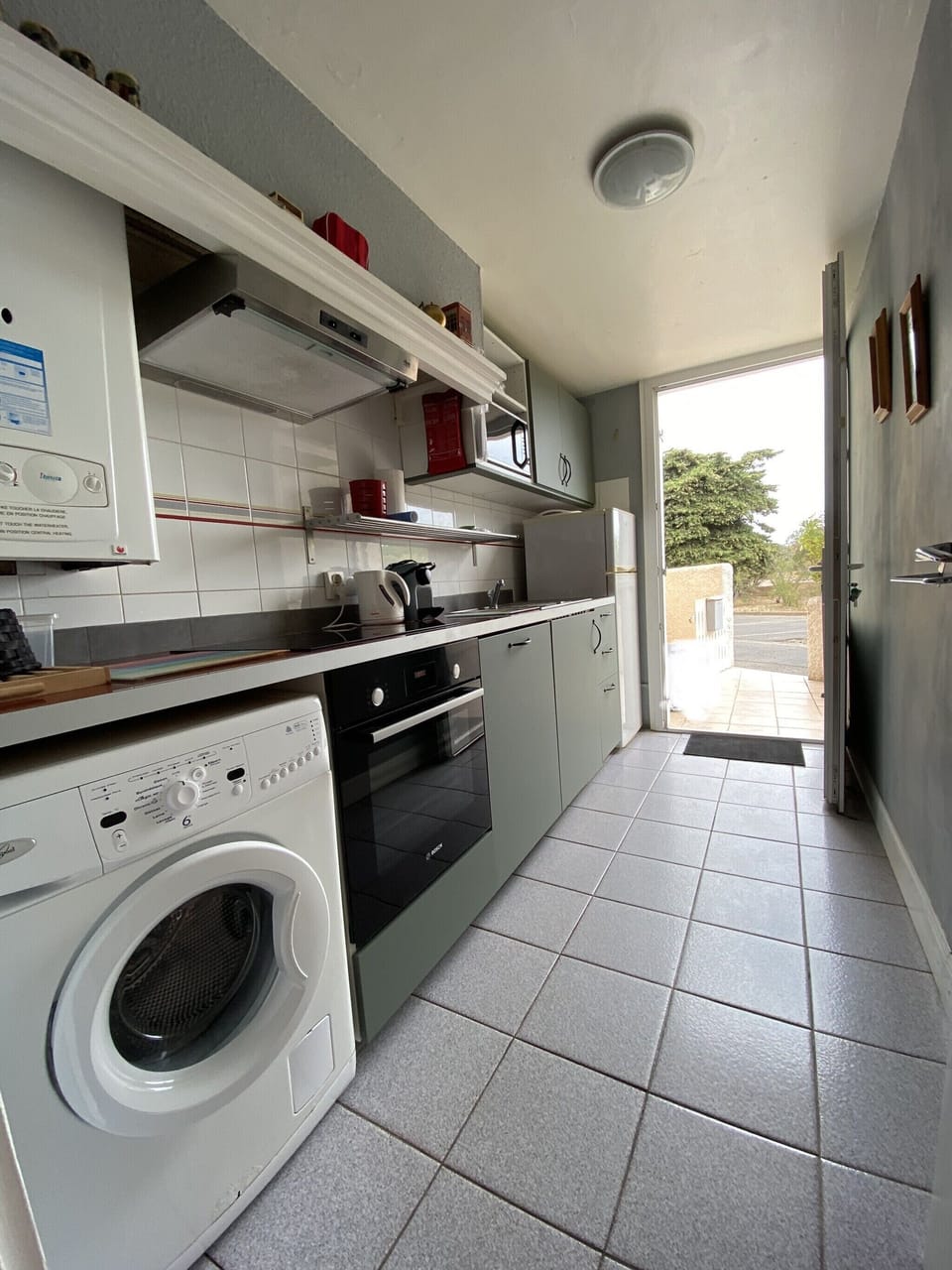Kitchen with view of parking space behind the terrace
