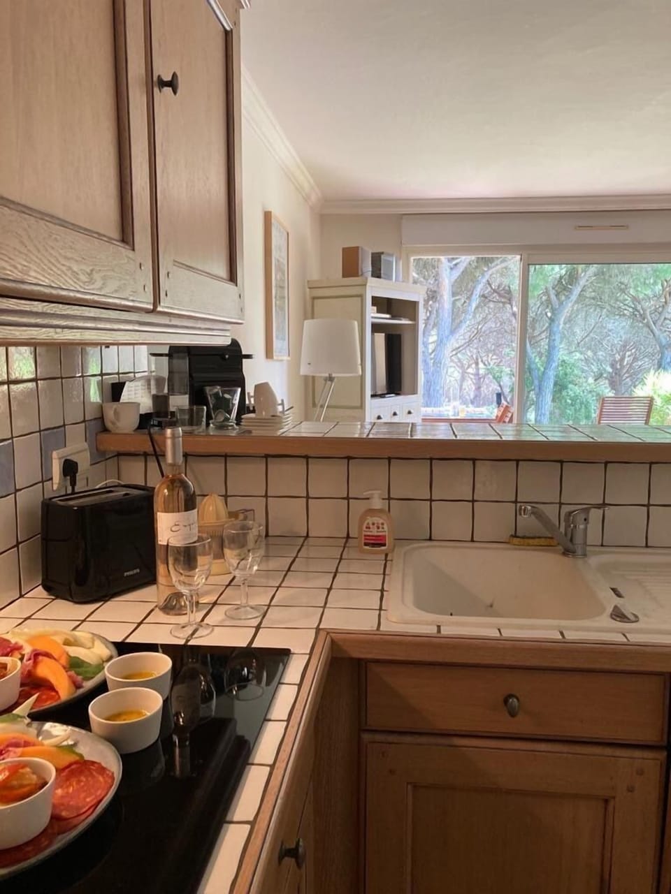 Behind the kitchen bar / counter.