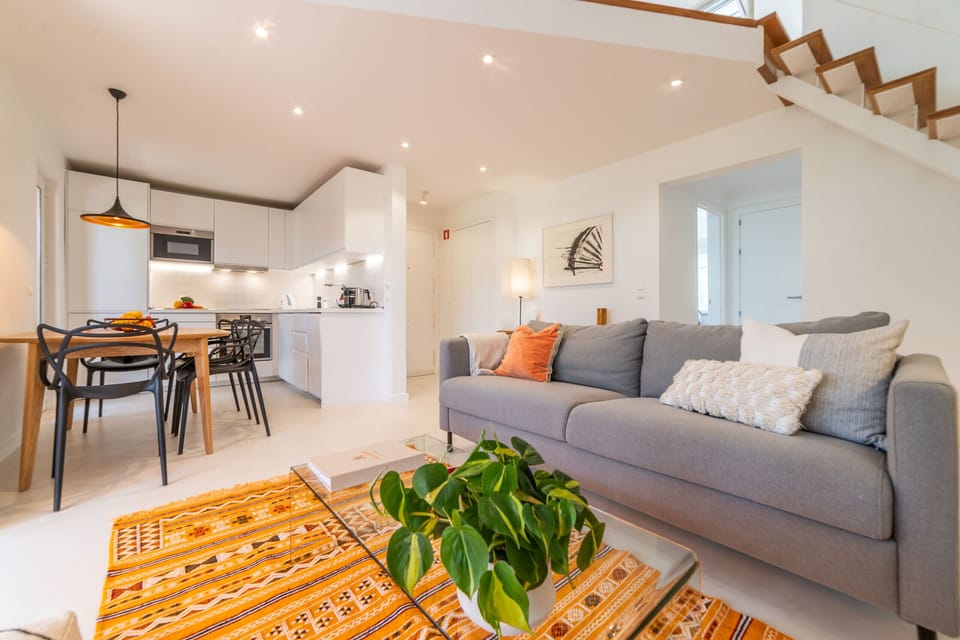 Bright open-plan living room with grey sofa and orange accents — Apartment Aroeira Golf II, holiday apartment in Portugal