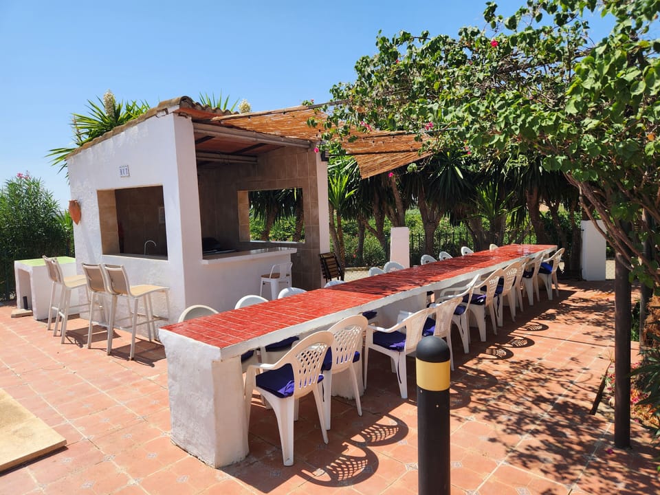 swimming pool eating area with bbq in the hut