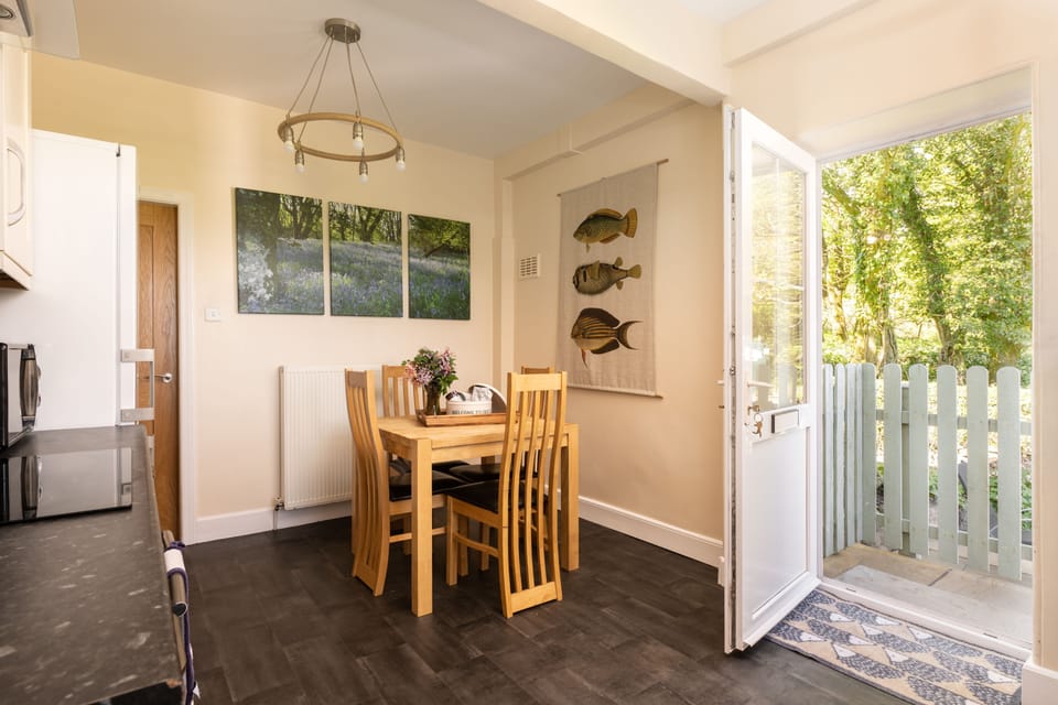 Light airy kitchen has door to patio and views over the wildflower meadow
