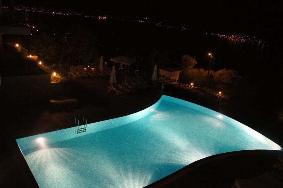 Night view of the illuminated pool.