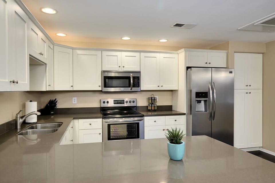 Upgraded kitchen with quartz counters and solid wood cabinets. 