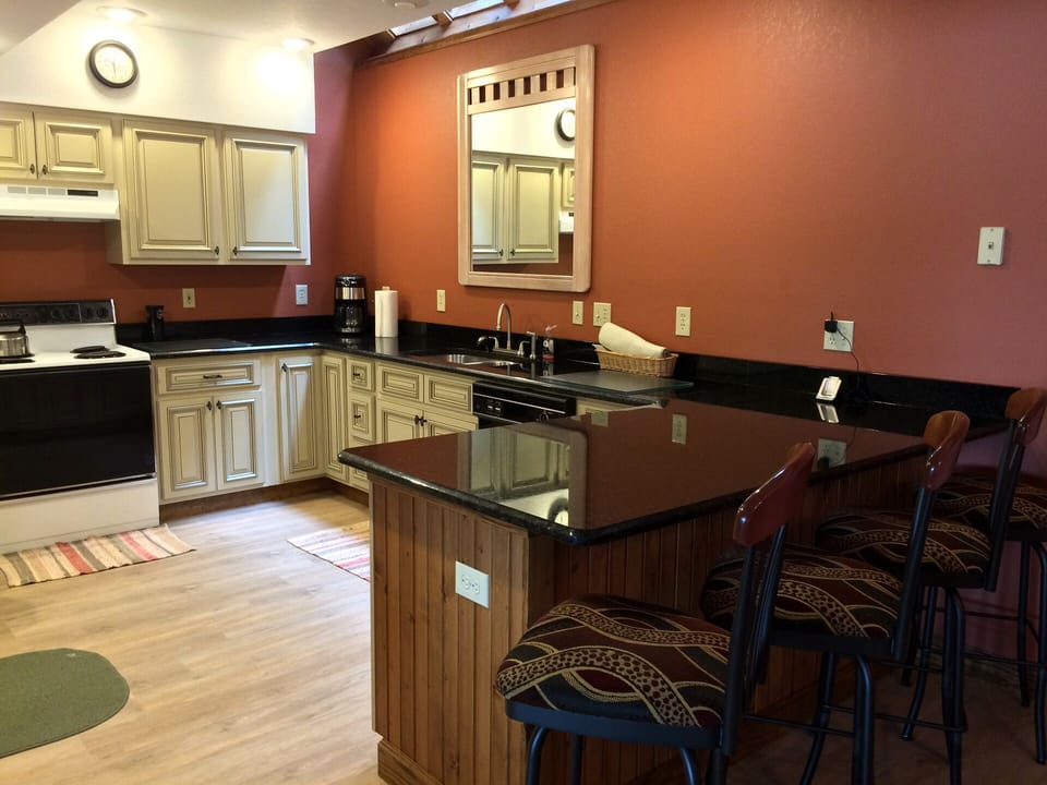 Lower Kitchen with new cabinets, granite counter tops, and floor.