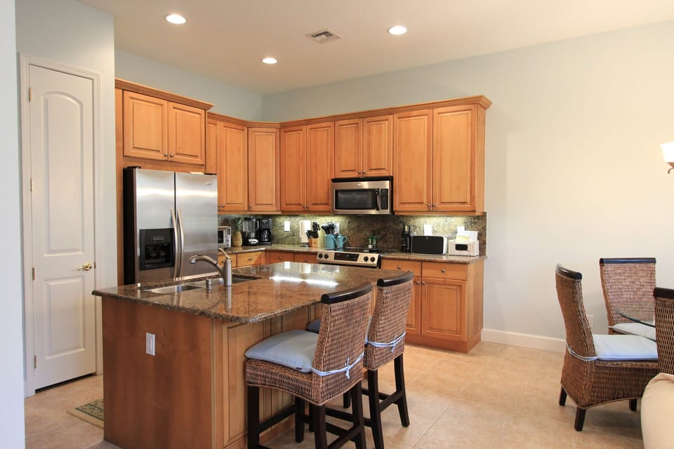 Open Kitchen, granite counter- tops and newer appliances bar seating