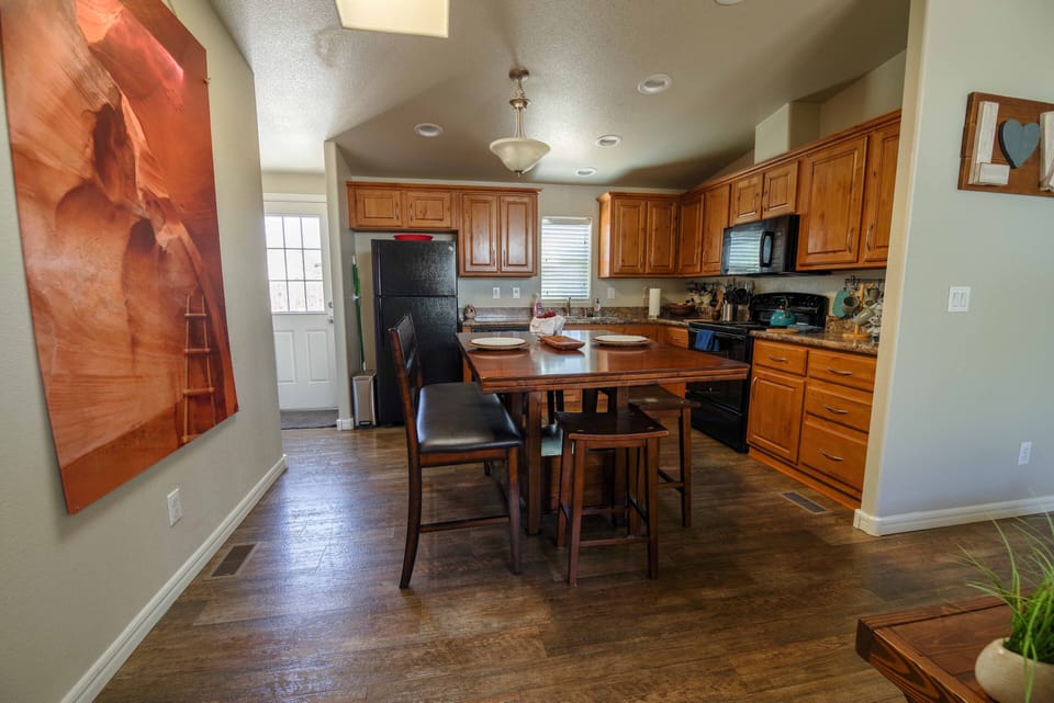 Kitchen with skylight, counter height dining table, dishwasher, fridge/freezer.