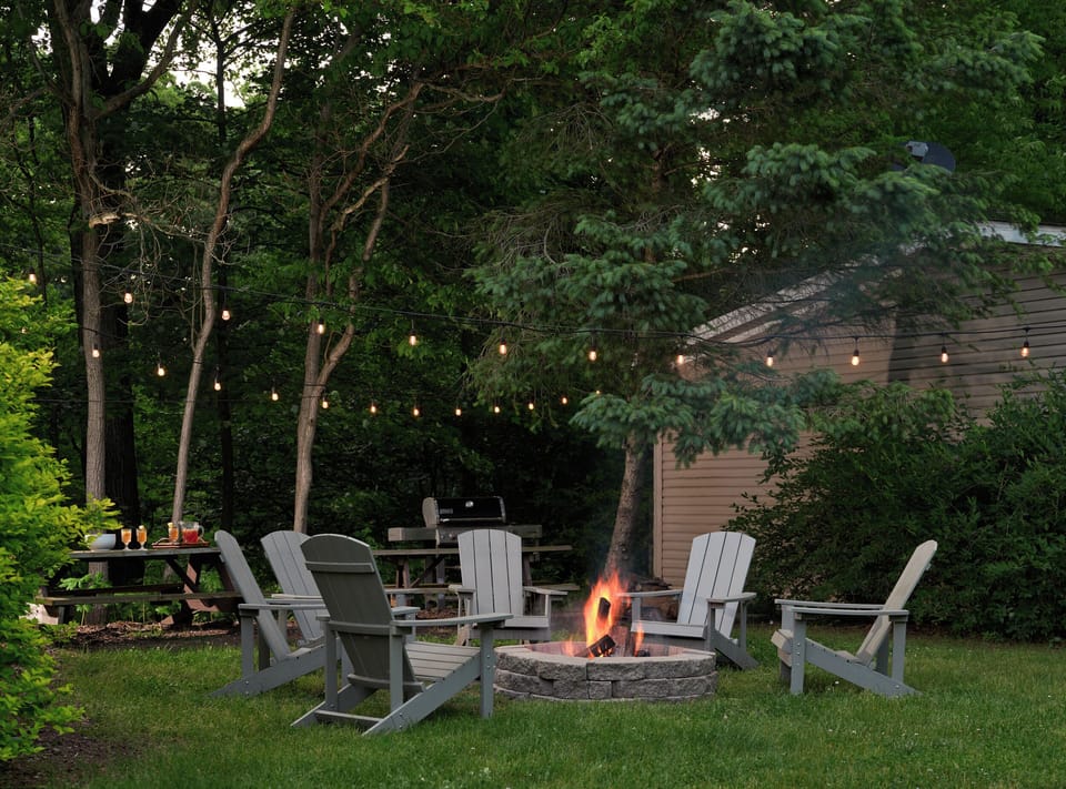 Fire pit with Adirondack chairs. Weber gas grill, picnic table, free firewood.
