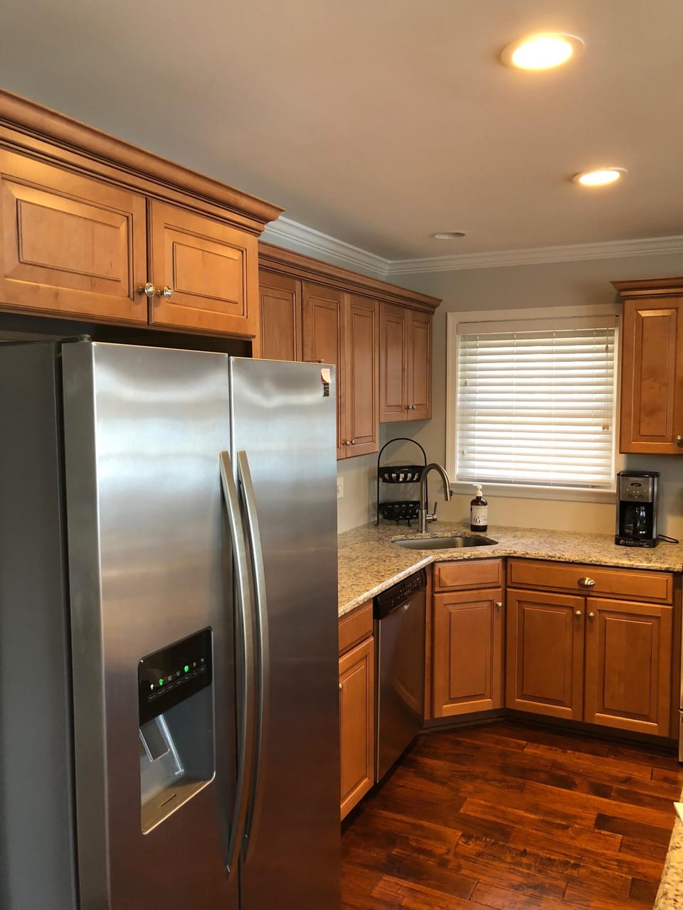 Modern updated kitchen with appliances and stocked pantry