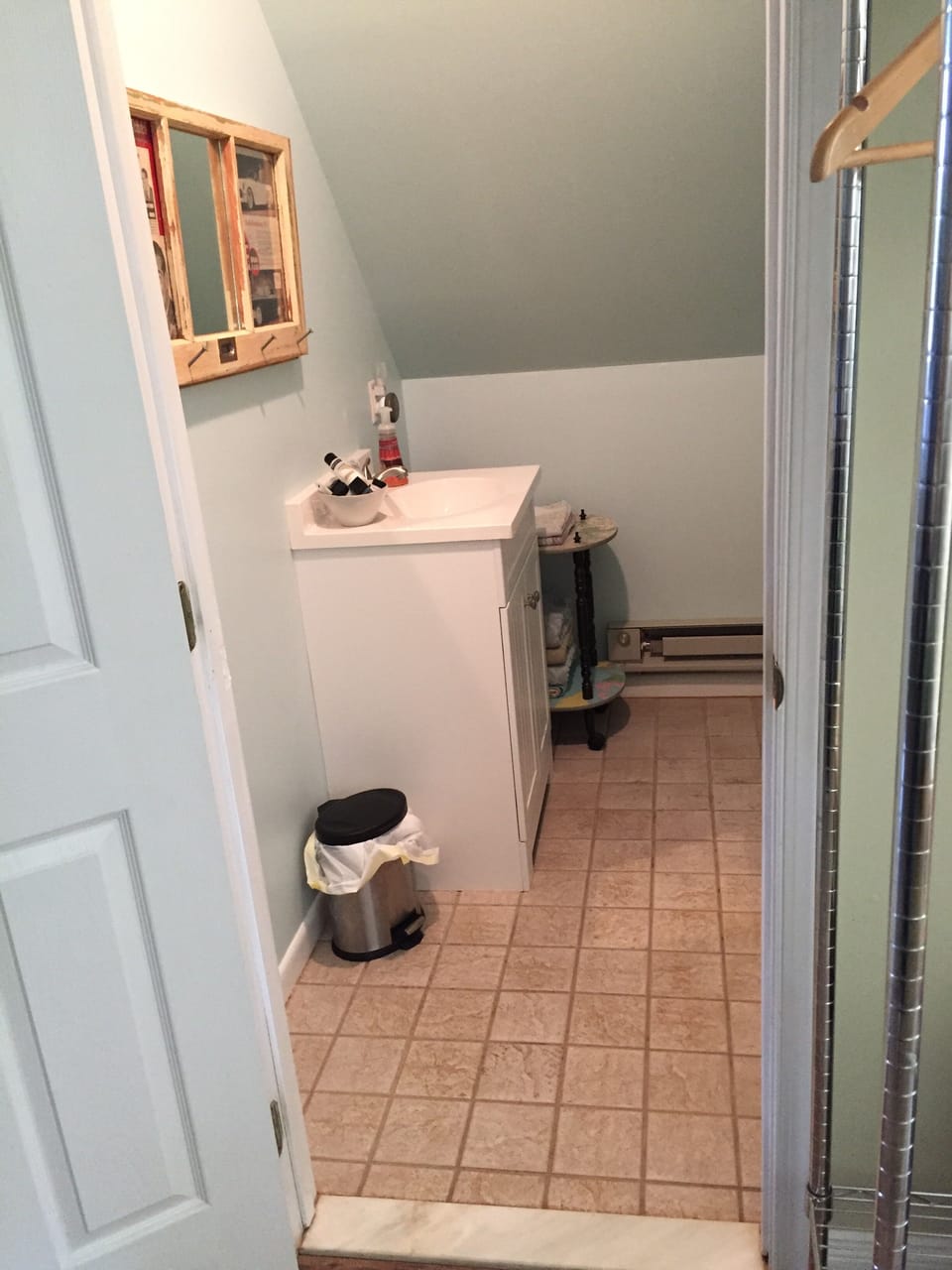 Bathroom has tile floors, a baseboard heater and shower stocked with essentials!