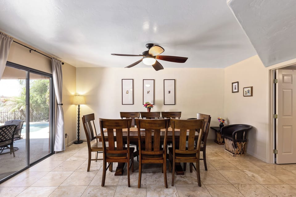 Spacious dining area with seating for 8 and views over the backyard and pool