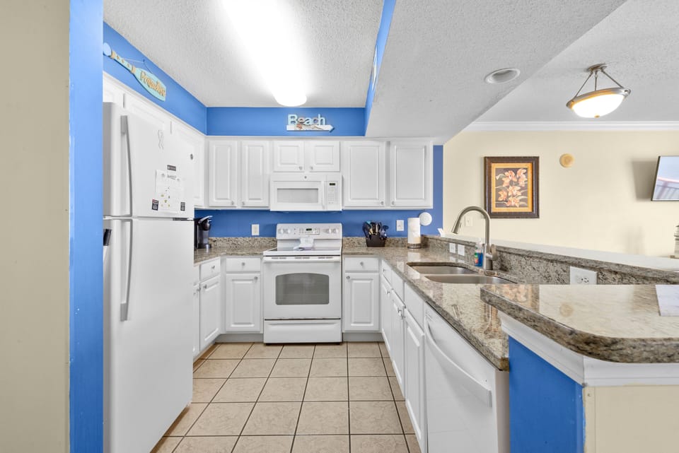 Large kitchen with granite counter tops, flat top stove and full size dishwasher